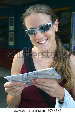 Young woman with city map in hands. Australia