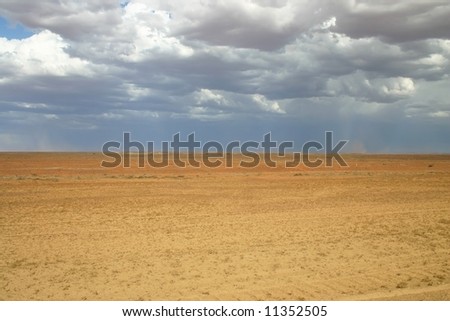 View over the barren land with cloudy sky before storm. Oodnadatta track, South Australia