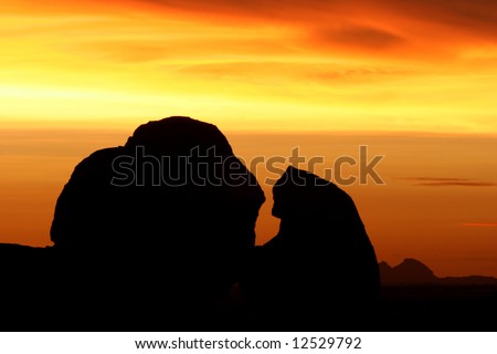 Silhouettes of Spitzkoppe rocks at colorful sunset scene. Namibia. Africa