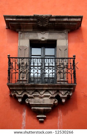 Colonial balcony. View on a typical urban scene with closed French window. San Miguel de Allende, Mexico