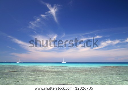 White luxury yachts anchored near famous summer resort Atoll Rangiroa. French Polynesia