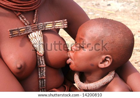 NAMIBIA - UNKNOWN: A woman holds her child while breast feeding in this undated image taken in Namibia. Africa