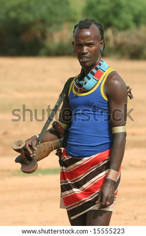 ETHIOPIA -  FEBRUARY 26: Indigenous man in traditional clothes with a gun posing in a desert. Great Trekking adventure February 26, 2004 in Ethiopia.