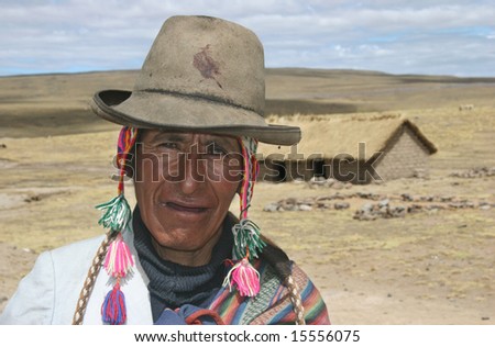 PERU - OCTOBER 05: Old indigenous man in traditional clothes posing in front of his poor house in highlands of Peru. Great trekking adventure October 05, 2005 in Peru.
