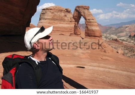 Young tourist admiring Delicate Arch. Arches national park. Utah. USA