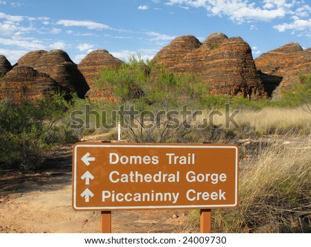 Signpost against shrubby vegetation and famous rock formations in background. Bungle Bungle national park, Western Australia. Australia
