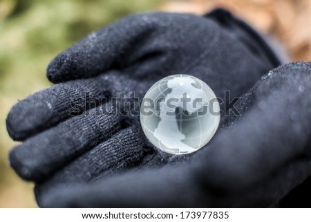 Glass world in your hand, winter Planet in the hands of winter