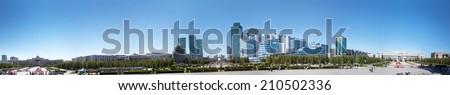 Panorama of Astana, city of the Republic of Kazakhstan Astana, Kazakhstan - August 10, 2014: The photograph depicts Astana city on a sunny day. Residents of the capital and the rest walk, ride bikes.
