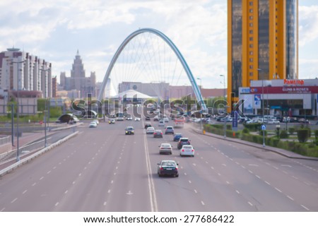 Astana the capital of Kazakhstan, blurred photo\
Astana, Kazakhstan - May 9, 2015: Astana, the right bank. The photograph shows a road located on the street Barayev. On the road, drive cars and buses.