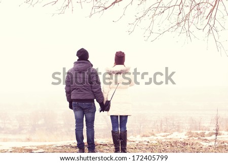 Young couple walking in winter park