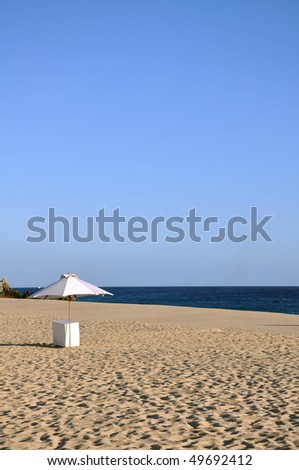 Umbrella stand on a beautiful beach shoreline in Cabo San Lucas, Baja California, Mexico