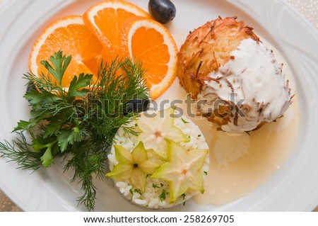 Greek kitchen: potato pie with chicken meat inside, rice and orange