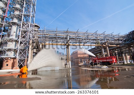 VORONEZH, RUSSIA - OCTOBER 4, 2012: Fire drill on city plant - firemen in protective clothing extinguish fire