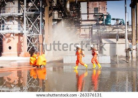 VORONEZH, RUSSIA - OCTOBER 4, 2012: Fire drill on city plant - firemen in protective clothing extinguish fire