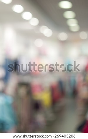 Blurred background: interior of kid\'s apparel shop, bokeh lights