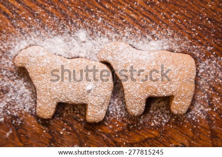 Cooking gingerbread - sheep-cookies covered with sugar powder - view from above
