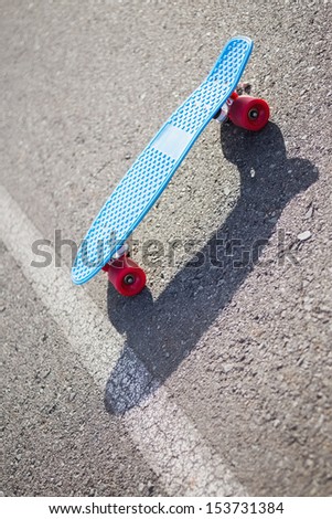 Colorful skateboard on a road in summertime