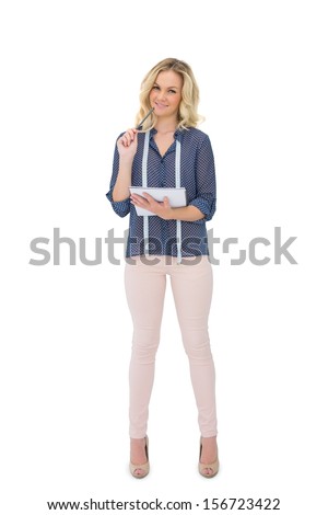 Thinking pretty fashion designer holding sketchpad on white background