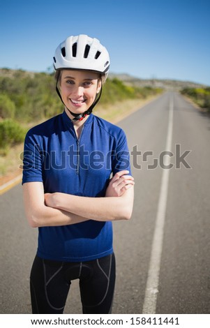 Woman with helmet crossing arms looking at camera