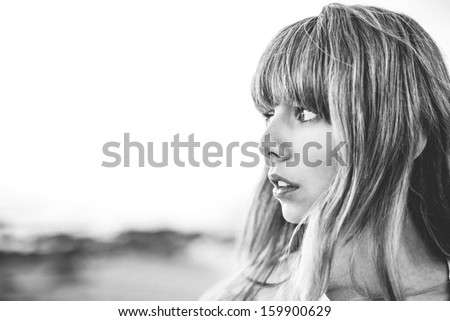 Hipster girl with fringe looking away in black and white artistic shot