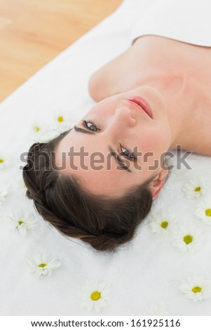 Close up portrait of a beautiful young woman with flowers in beauty salon
