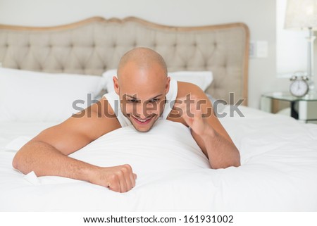 Close up of a young man cheering in bed at home