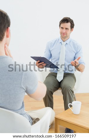 Well dressed male doctor in conversation with patient in the medical office