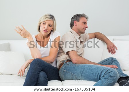 Angry couple having a fight in the living room at house