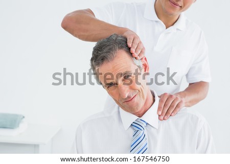 Close-up of a male chiropractor doing neck adjustment in the hospital