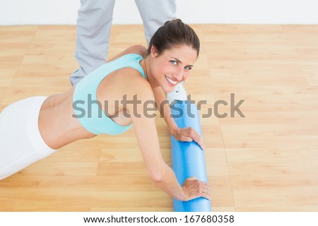 Side view portrait of a young woman do push ups in the gym at hospital