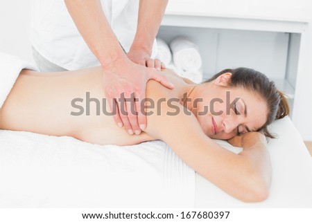 Close-up of male physiotherapist massaging woman\'s back in the medical office