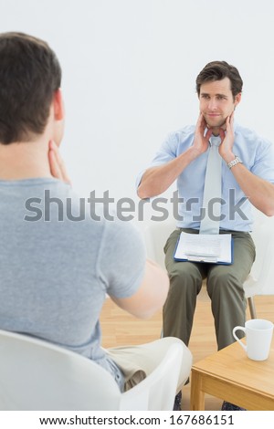 Well dressed male doctor in conversation with patient in the medical office