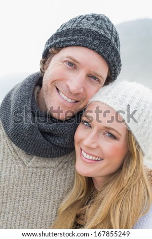 Close-up portrait of a romantic young couple in warm clothing outdoors