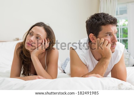Unhappy couple not talking after an argument in bed at home