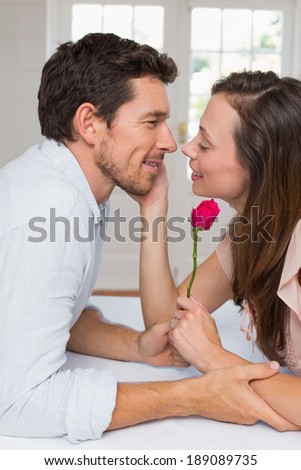 Side view of a loving young couple looking at each other at home