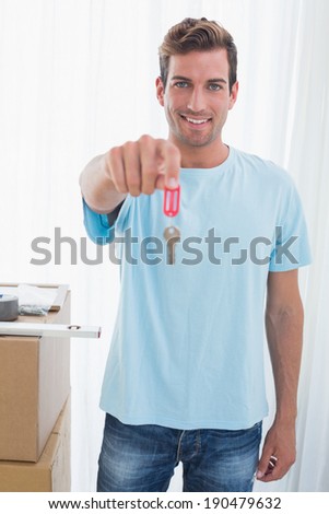 Portrait of a happy young man holding out new house key