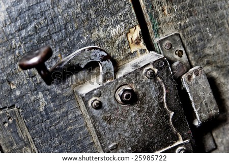 Old handle in wooden doors, hdr technique. Focus on locking  mechanism.