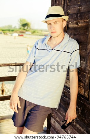 Young man is standing on a bech tower.