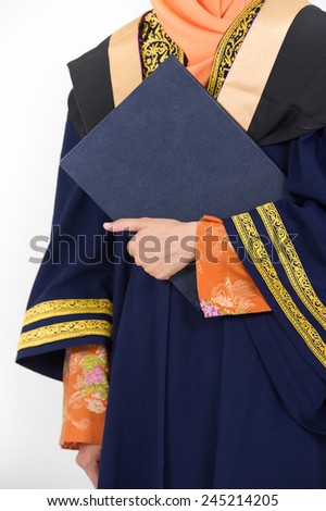 Young mother college graduate holding degree after convocation ceremony.