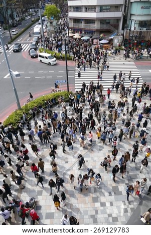 TOKYO - APRIL 11 2015: Crowds of people walking through Harajuku on Saturday April 11 2012. Harajuku is known internationally as a center of Japanese youth culture and fashion.
