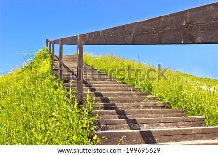 Stairs to deep blue sky on green hill. Abstract natural backgrounds. Horizontal image