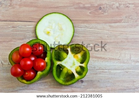 Fresh vegetables at wooden background close up. Horizontal image. Objects at the left part of image