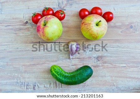 Funny smiling face. Conceptual horizontal image with vegetables. Objects at the central part of image