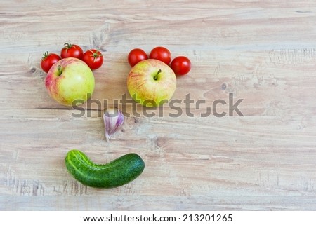 Funny smiling face. Conceptual horizontal image with vegetables. Objects at the left part of image