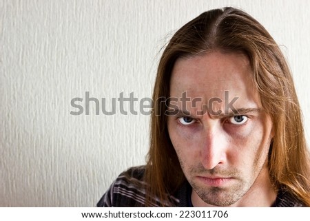 Serious long hair man portrait looking at camera