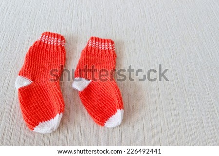 Colorful wool baby socks isolated on white background. Socks at the left part of image