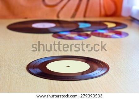 Vinyl record disk with another discs at blurred background