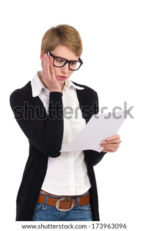 Sad young woman reading documents. Three quarter length studio shot isolated on white.