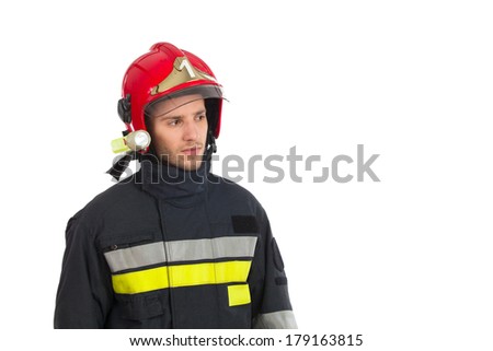 Fireman in red helmet looking away. Head and shoulders studio shot isolated on white.