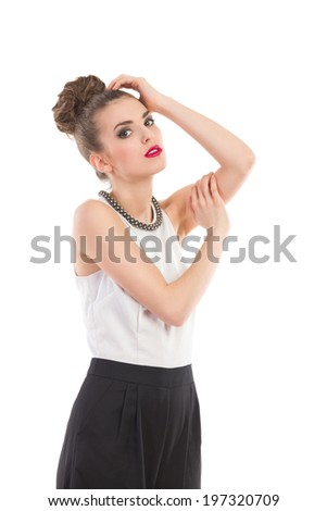 Elegance fashion model is posing. Three quarter length studio shot isolated on white.